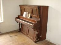 This old piano still appears in working condition.